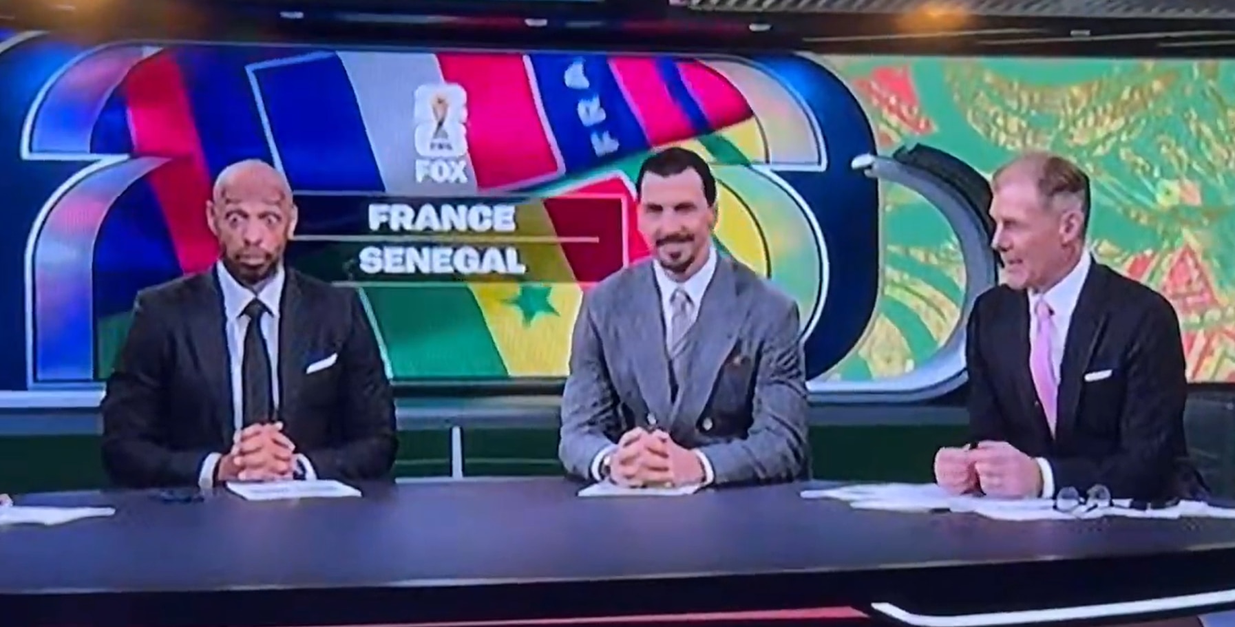 Thierry Henry sits next to Zlatan Ibrahimovic and Alexi Lalas in the Fox Studio.
