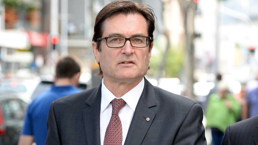 Former Climate Change minister Greg Combet leaves the Magistrates Court in Brisbane.