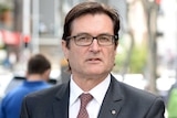 Former Climate Change minister Greg Combet leaves the Magistrates Court in Brisbane.