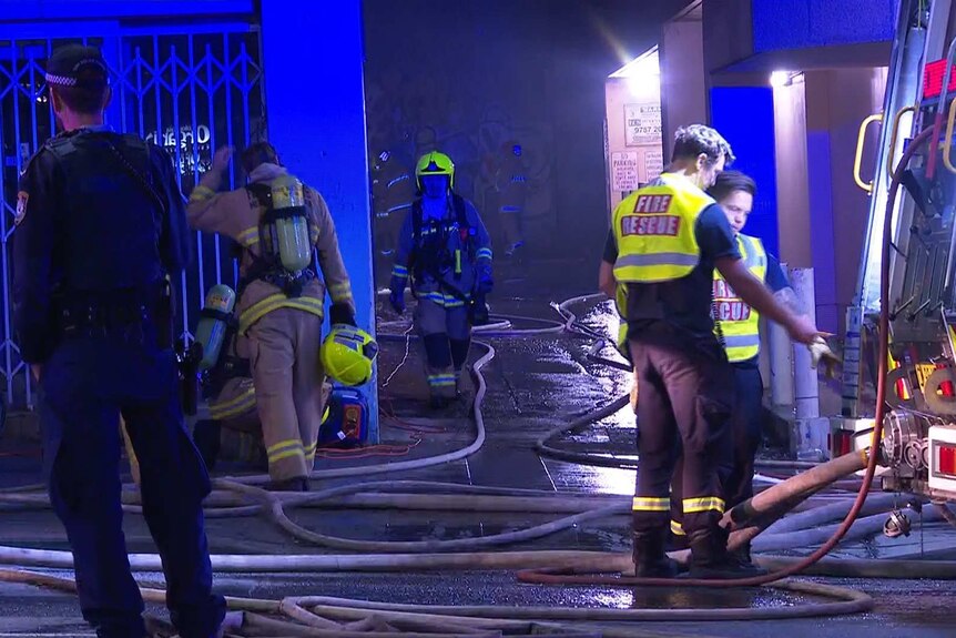 firefighters outside a dark building