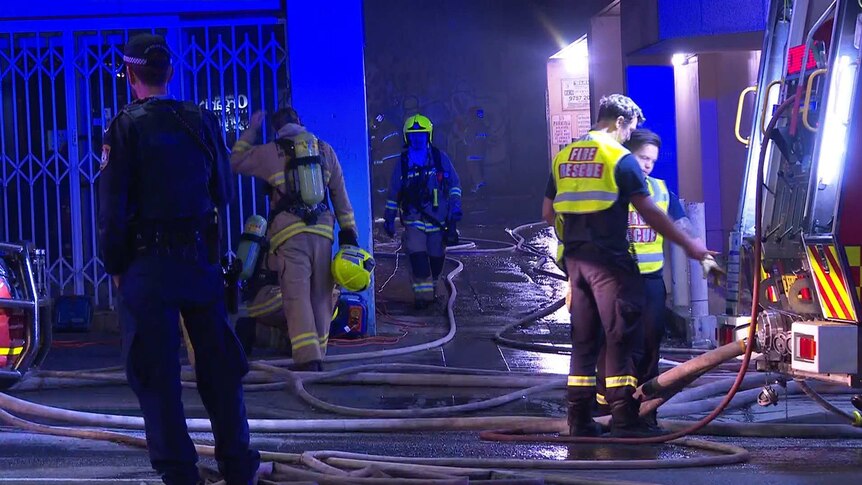 firefighters outside a dark building