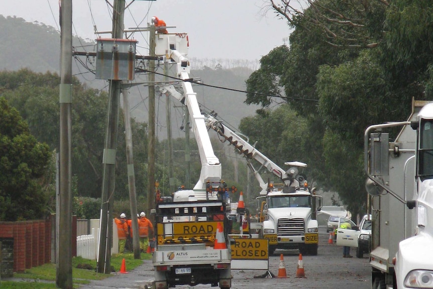 Workers repair power lines damaged by severe winds in Northern Tasmania.