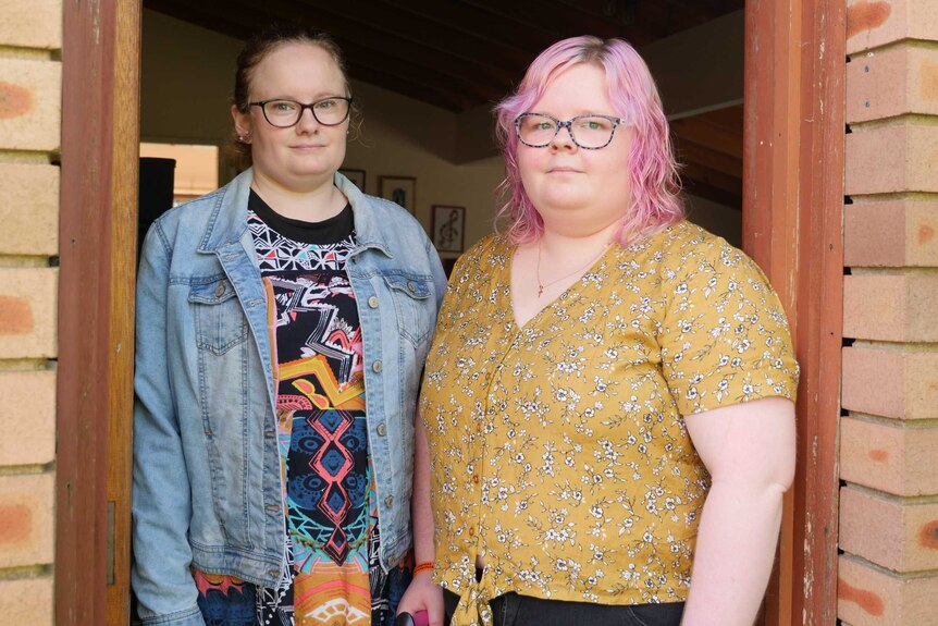 Emily and Heather McIntyre stand outside their home in Sydney, April, 2020.