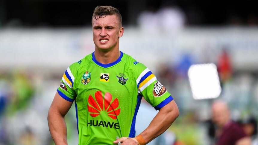 NRL player Jack Wighton stands with his hands on his hips on a playing field