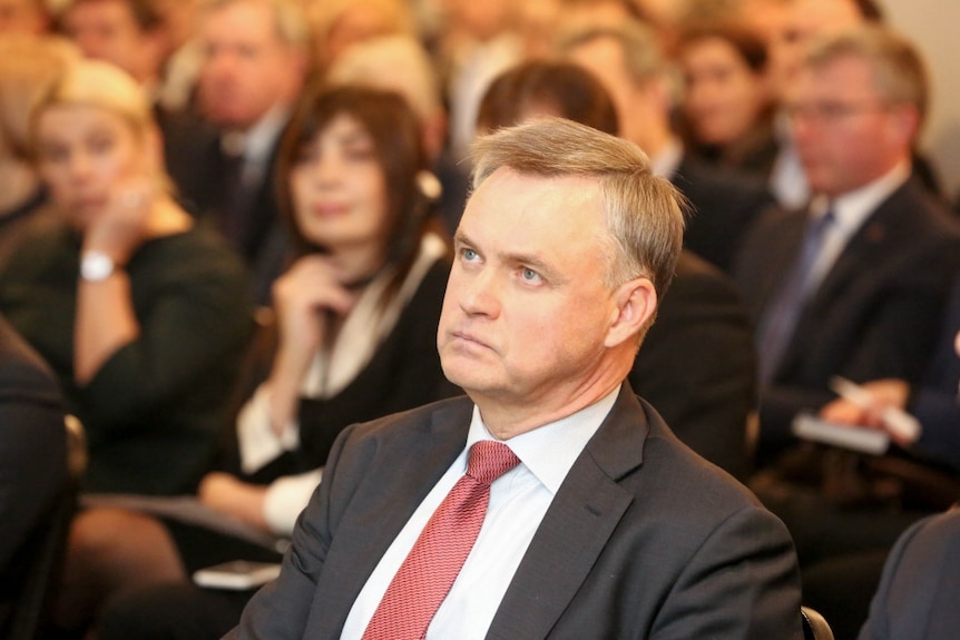 Head and shoulders shot of man in business attire.