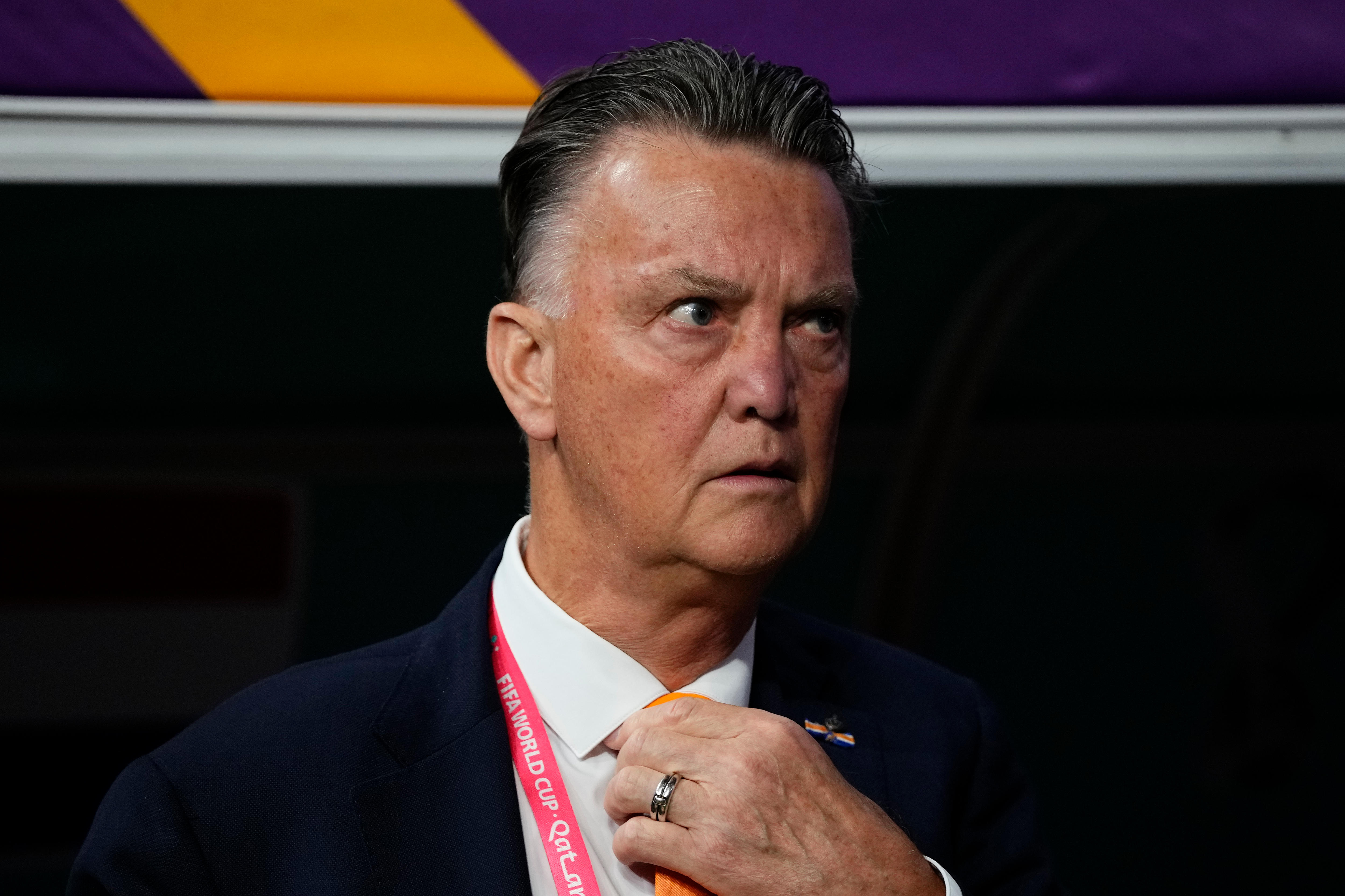 Louis van Gaal looks serious while wearing a suit on the touchline