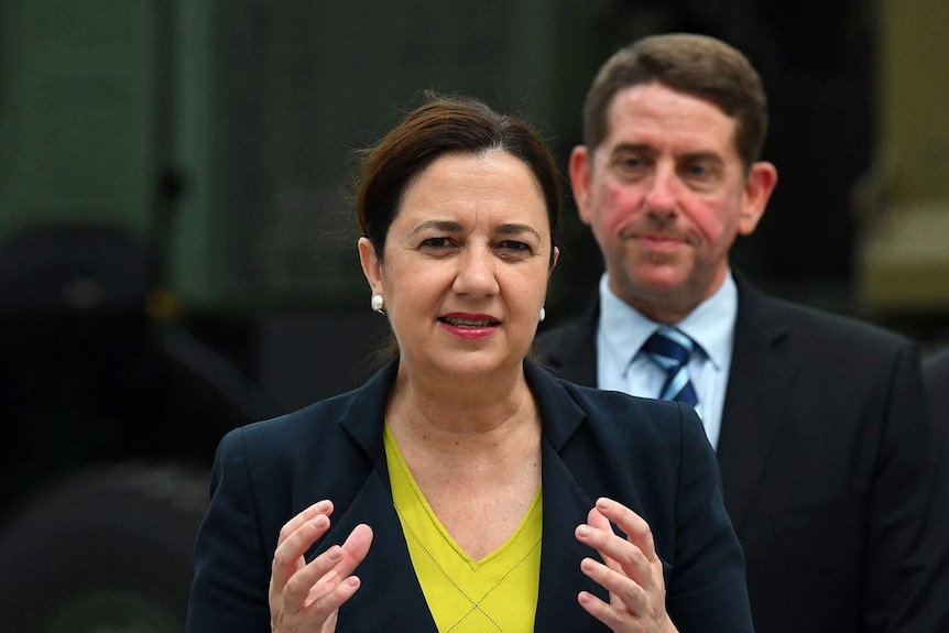 Queensland Premier Annastacia Palaszczuk with Labor Minister Cameron Dick behind her.