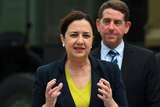 Queensland Premier Annastacia Palaszczuk with Labor Minister Cameron Dick behind her.
