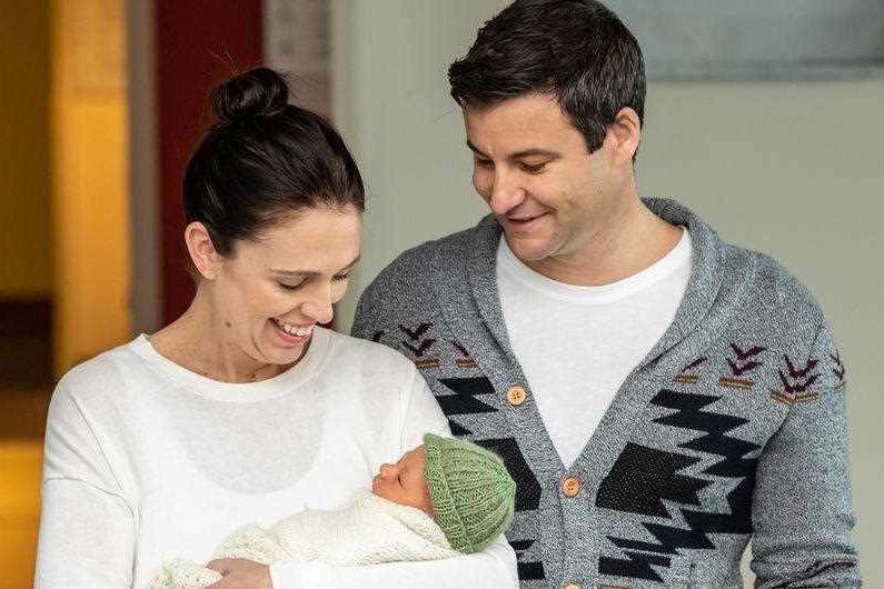 New Zealand Prime Minister Jacinda Ardern and her partner Clarke Gayford look down lovingly at their baby daughter