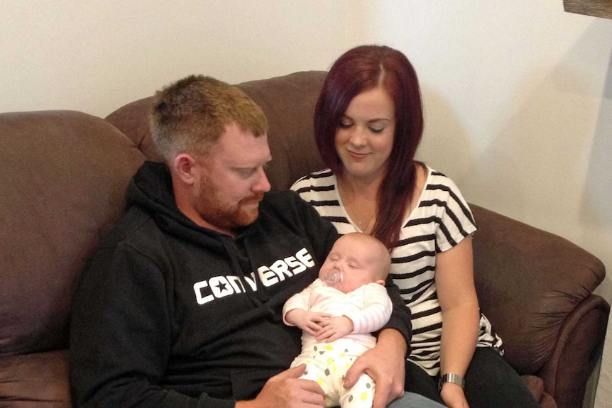 Devonport woman Holly Gleeson with her partner holding the baby born through surrogacy.