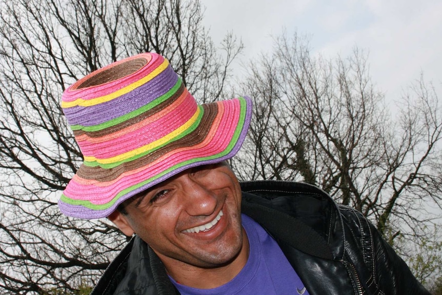 A man wearing a colourful hat