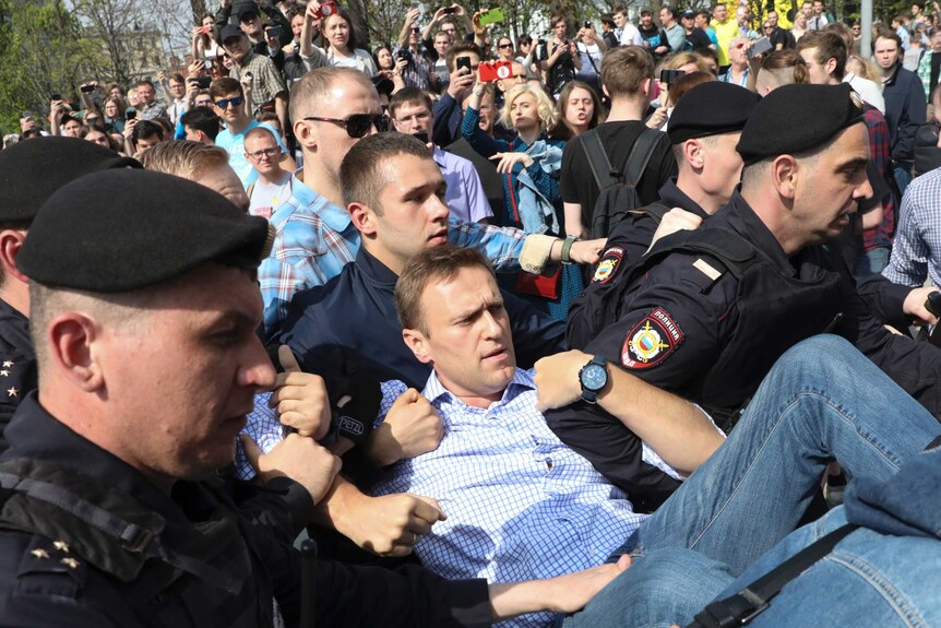 Russian police carry struggling opposition leader Alexei Navalny