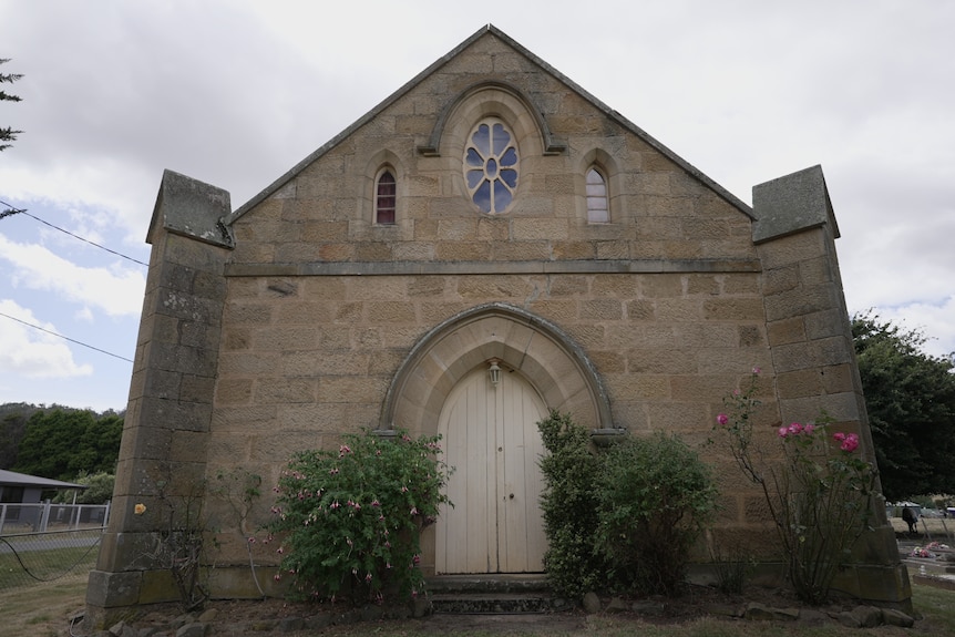 A church exterior on a cloudy day.