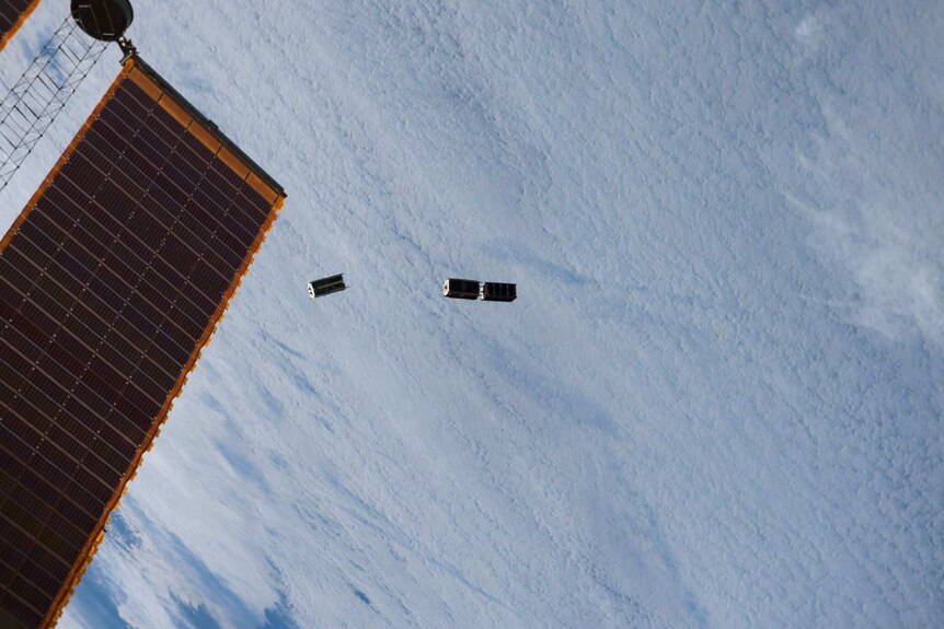 Small satellites float in space.