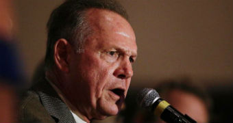 Judge Roy Moore speaks into a microphone.