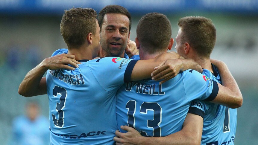 Alex Brosque celebrates with Sydney FC team-mates after goal against Mariners