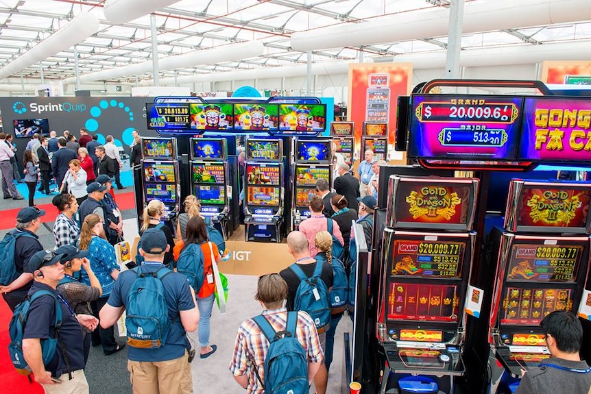 People looking over the wares of gaming machine manufacturers products at the Gaming Technologies Association 2016 expo.