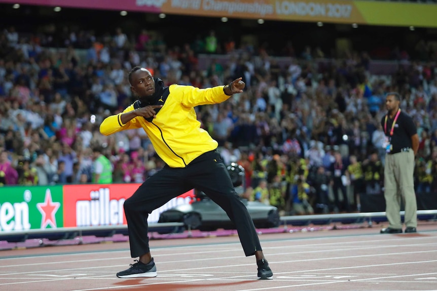 Usain Bolt makes his lightning bolt gesture at the end of a lap of honour in London