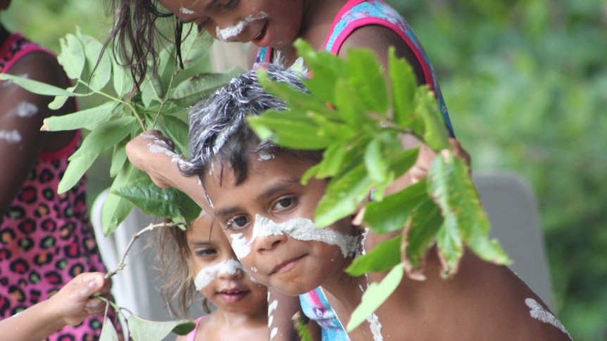 Young aboriginal boy looking at the camera outside in Yarrabah