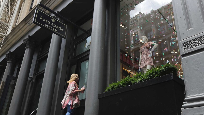 A woman enters the Kate Spade store in New York's Soho neighbourhood