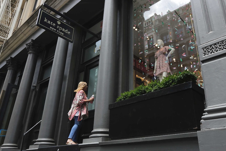 A woman enters the Kate Spade store in New York's Soho neighbourhood