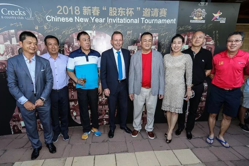 Tony Abbott and Jack Lam stand with a group of other people.