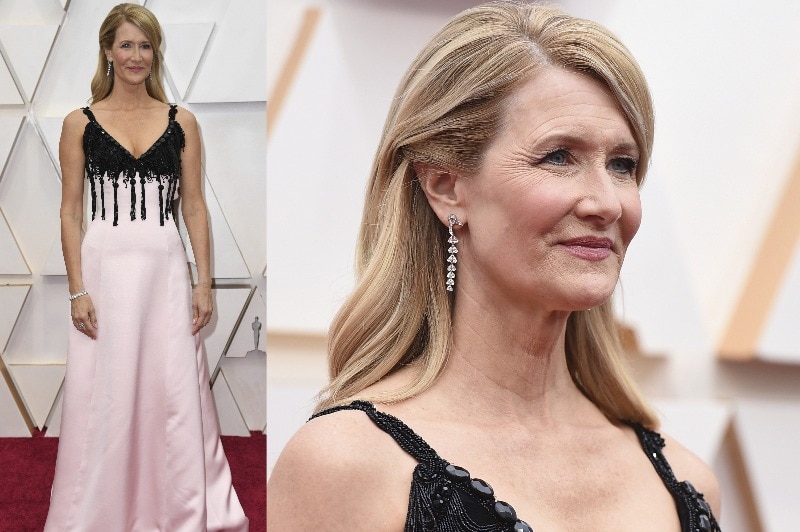 Laura Dern wearing a thin-strapped pale pink gown with black beading detail on top.