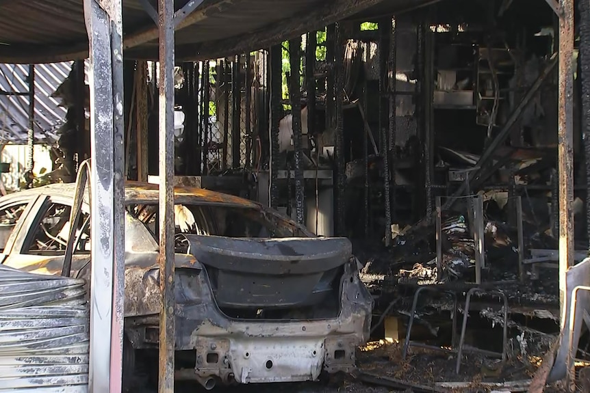 a burned out car in a burned out garage
