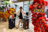Dragon and Lion performers welcome a Chinese tourist arriving at the Ninoy Aquino International Airport in Manila 