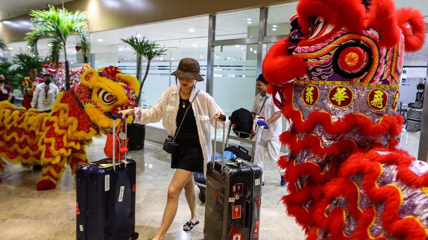 Dragon and Lion performers welcome a Chinese tourist arriving at the Ninoy Aquino International Airport in Manila 
