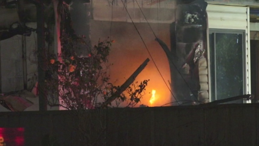 A flame can be seen inside a property.