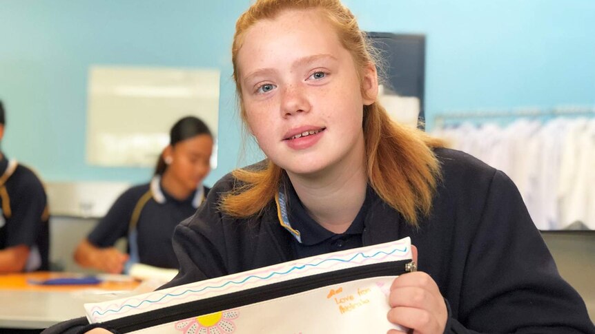 Year 8 student Alesyia Freeman holds a pencil case she has written inspiration notes on.