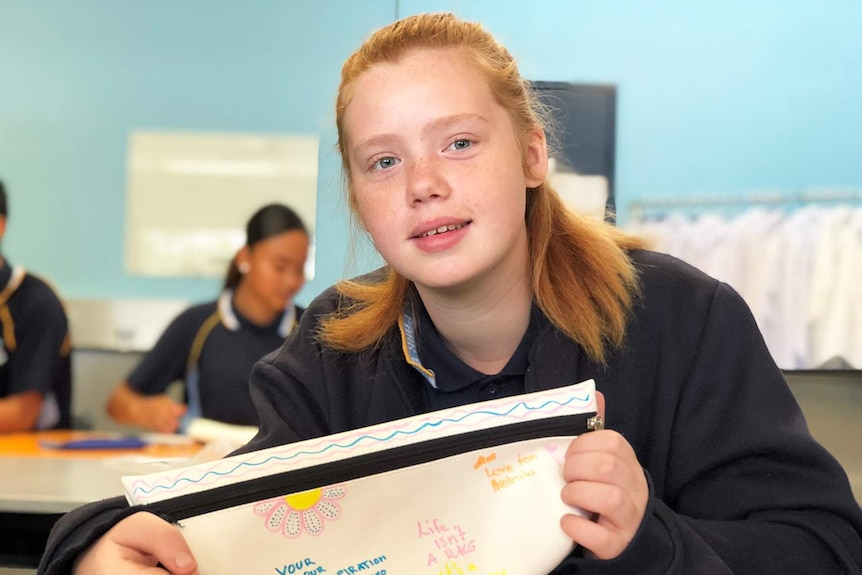 Year 8 student Alesyia Freeman holds a pencil case she has written inspiration notes on.