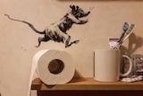 A painting of a rat runs on a toilet roll in a bathroom.