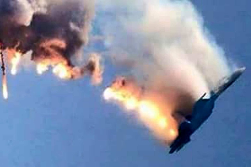 A burning Russian fighter jet coming down after being shot down near the Turkish-Syrian border