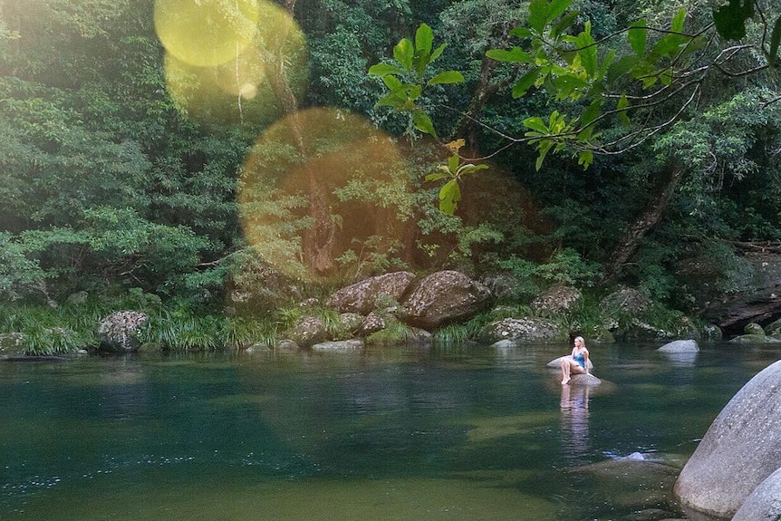 Woman sitting on rock