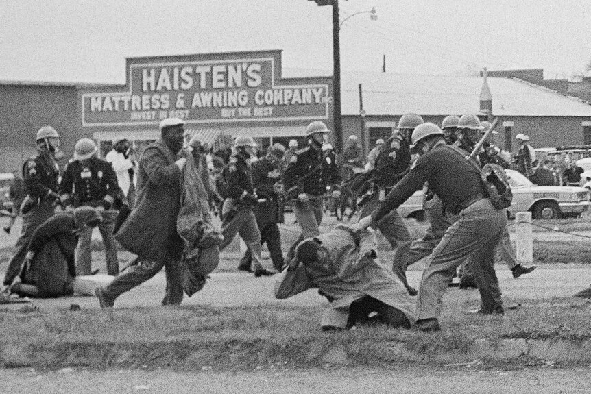 Police officers attack protesters during protests in Selma, Alabama.