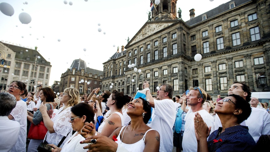White balloons are released into the air in honour of MH17 victims
