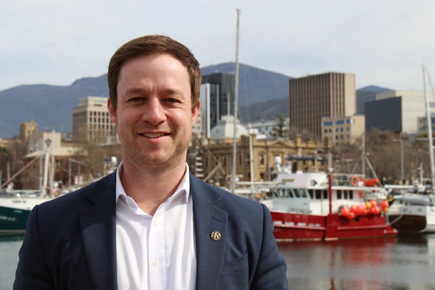 A man stands on the Hobart waterfront