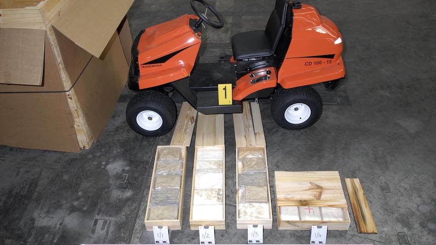 Some of the 270 kilograms of cocaine sits next to one of the lawnmowers in which it was hidden