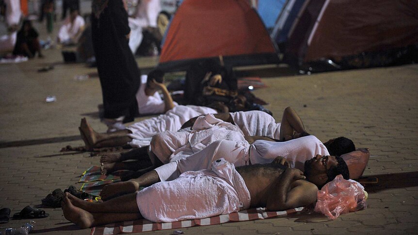 Muslim pilgrims sleep on the ground near Mount Arafat