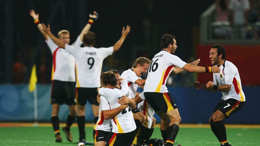 The German team rejoice after their first men's hockey gold since 1992.