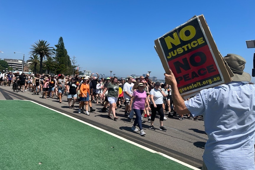 Hundreds of people walking in protest of Invasion Day.