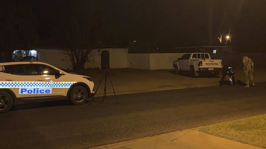 A police vehicle on a dark street.