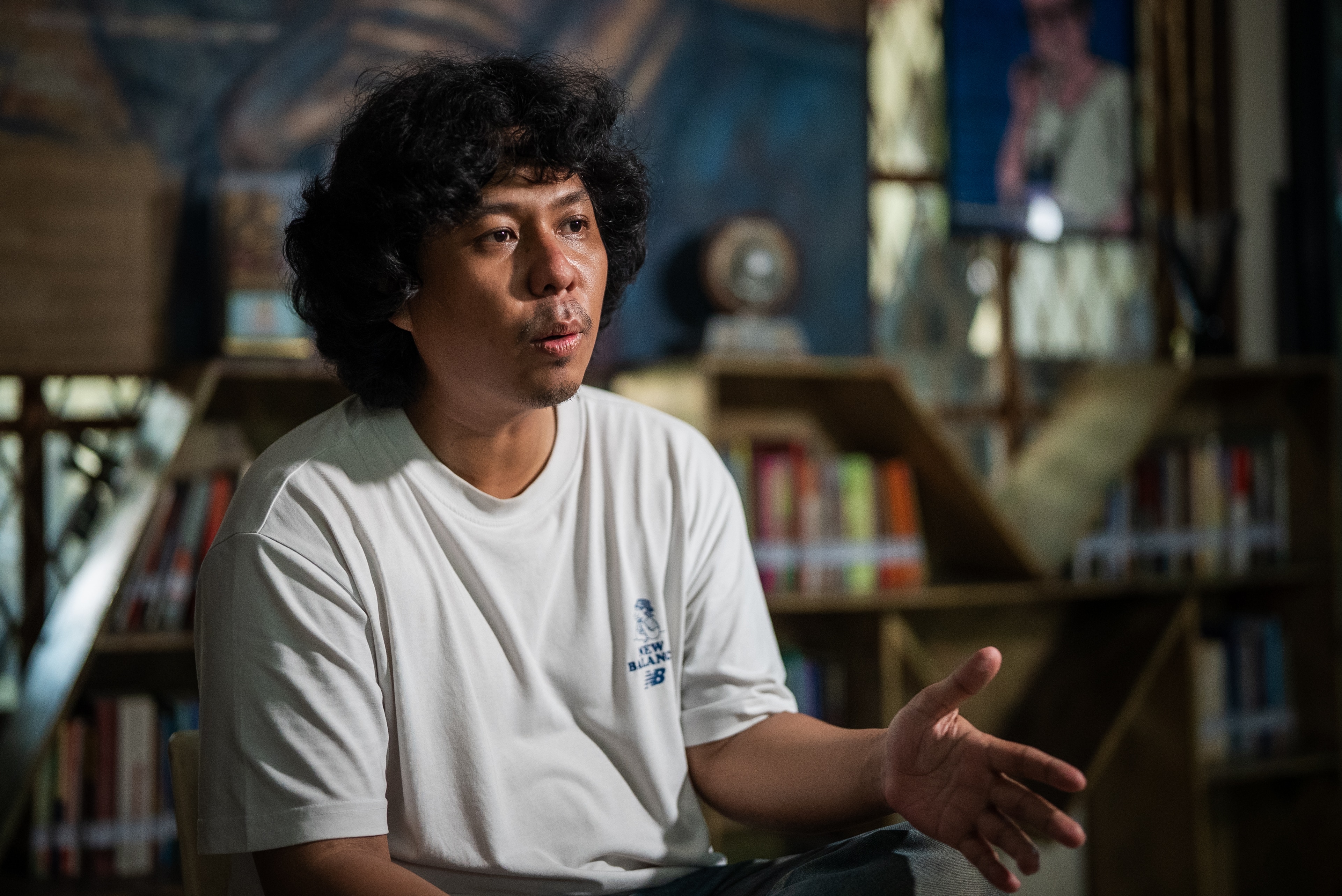 A close up of an Indonesian man wearing a white shirt.