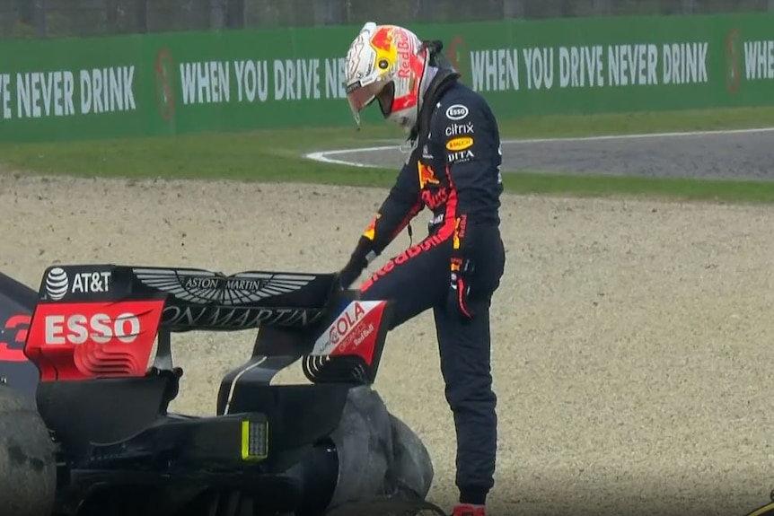 Max Verstappen kicks the tyre of his crashed Red Bull.