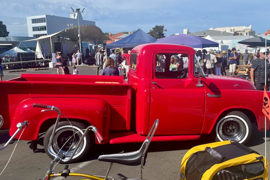 A vintage pick-up truck on display at a car festival.