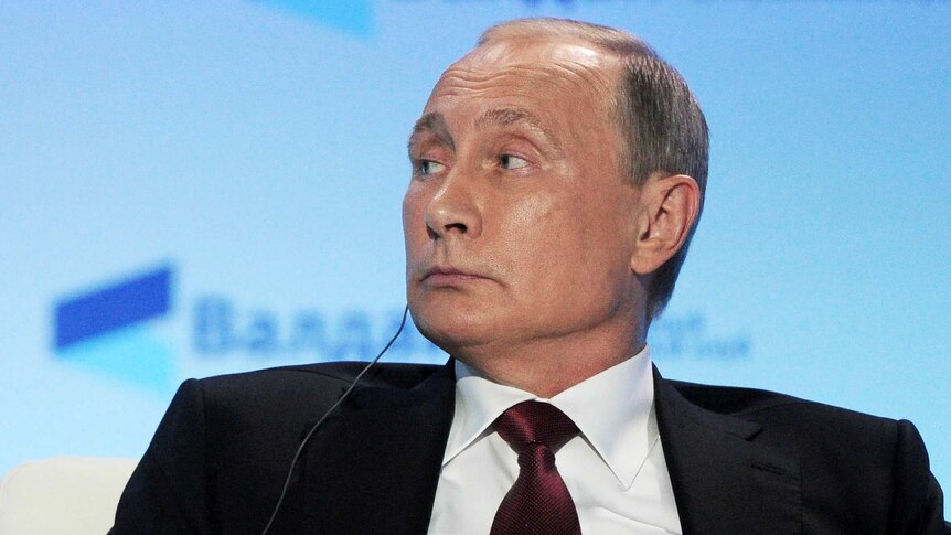 Russian President Vladimir Putin attends a session.