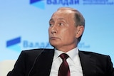 Russian President Vladimir Putin attends a session.