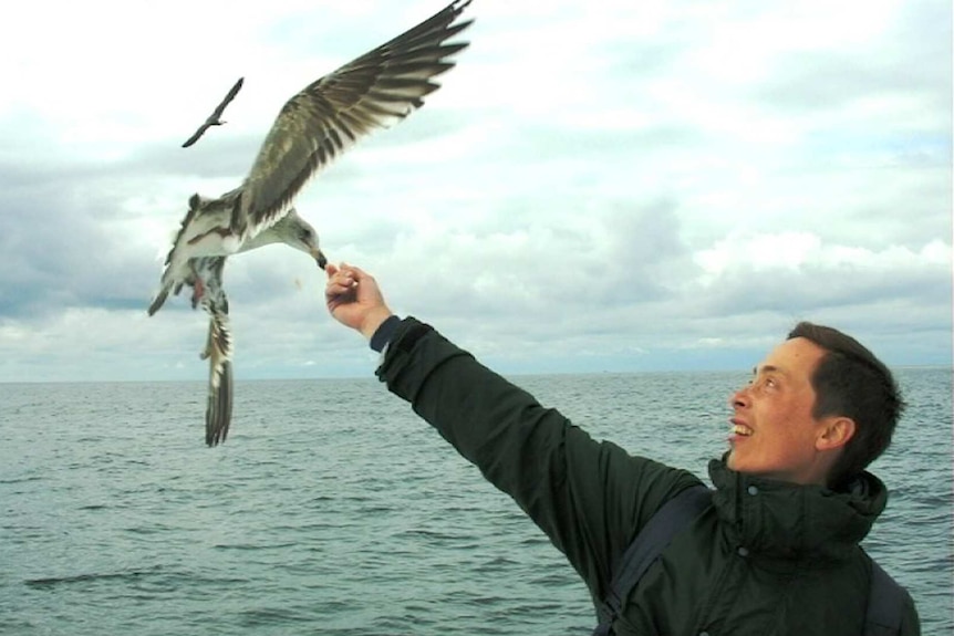 Michael Lee feeding a seagull